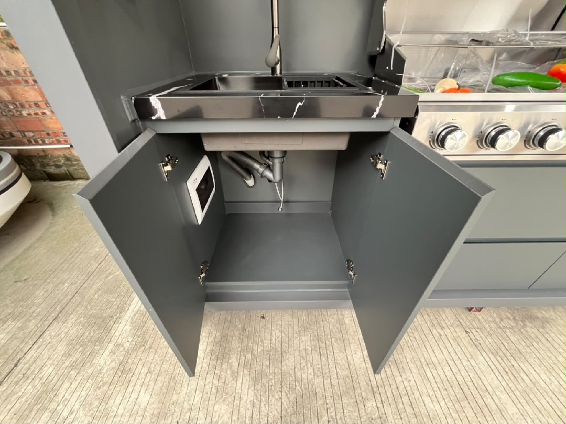 Under-sink storage with plumbing integration